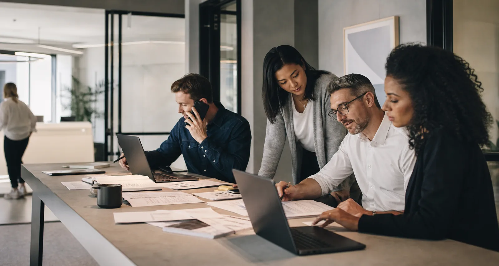 A professional operations team coordinating customer work in a modern office